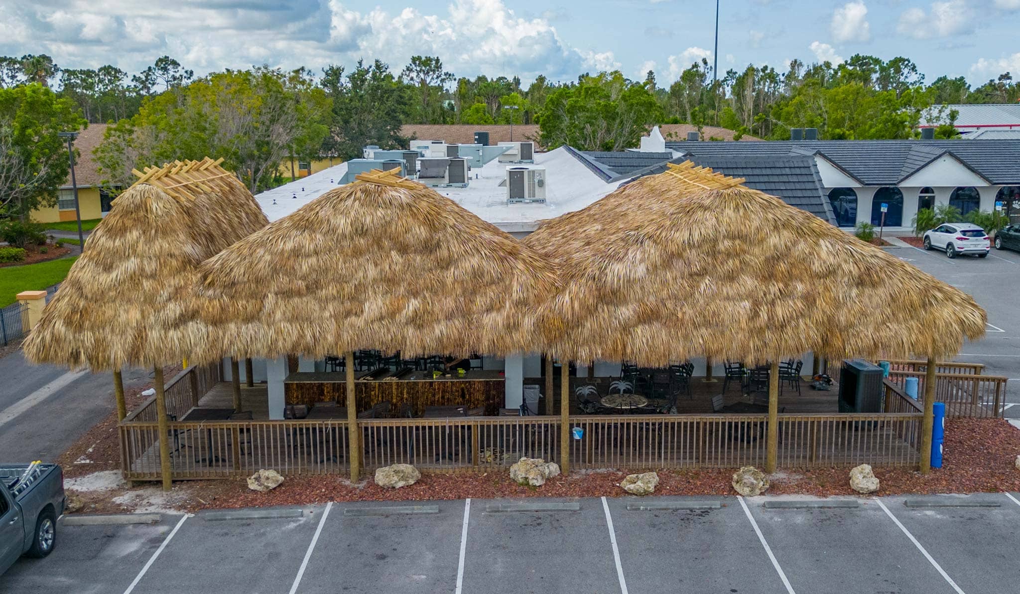 Tiki huts built over seating outside beef franks restaurant